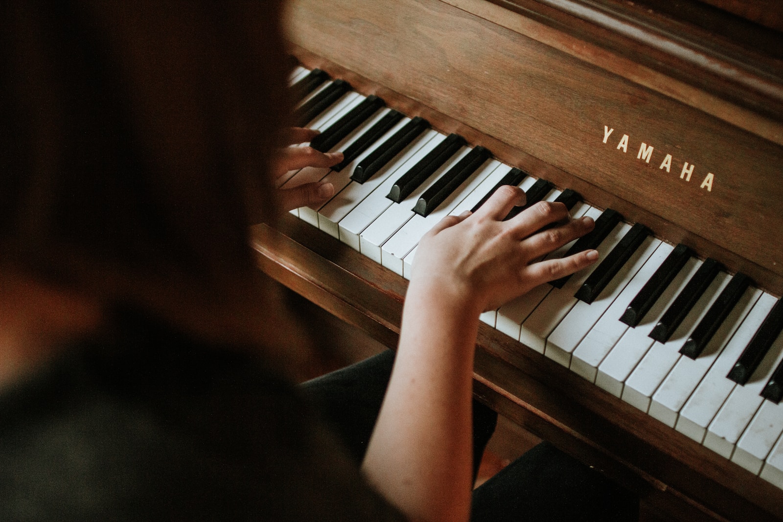 Photo by Jordan Whitfield woman playing Yamaha piano
