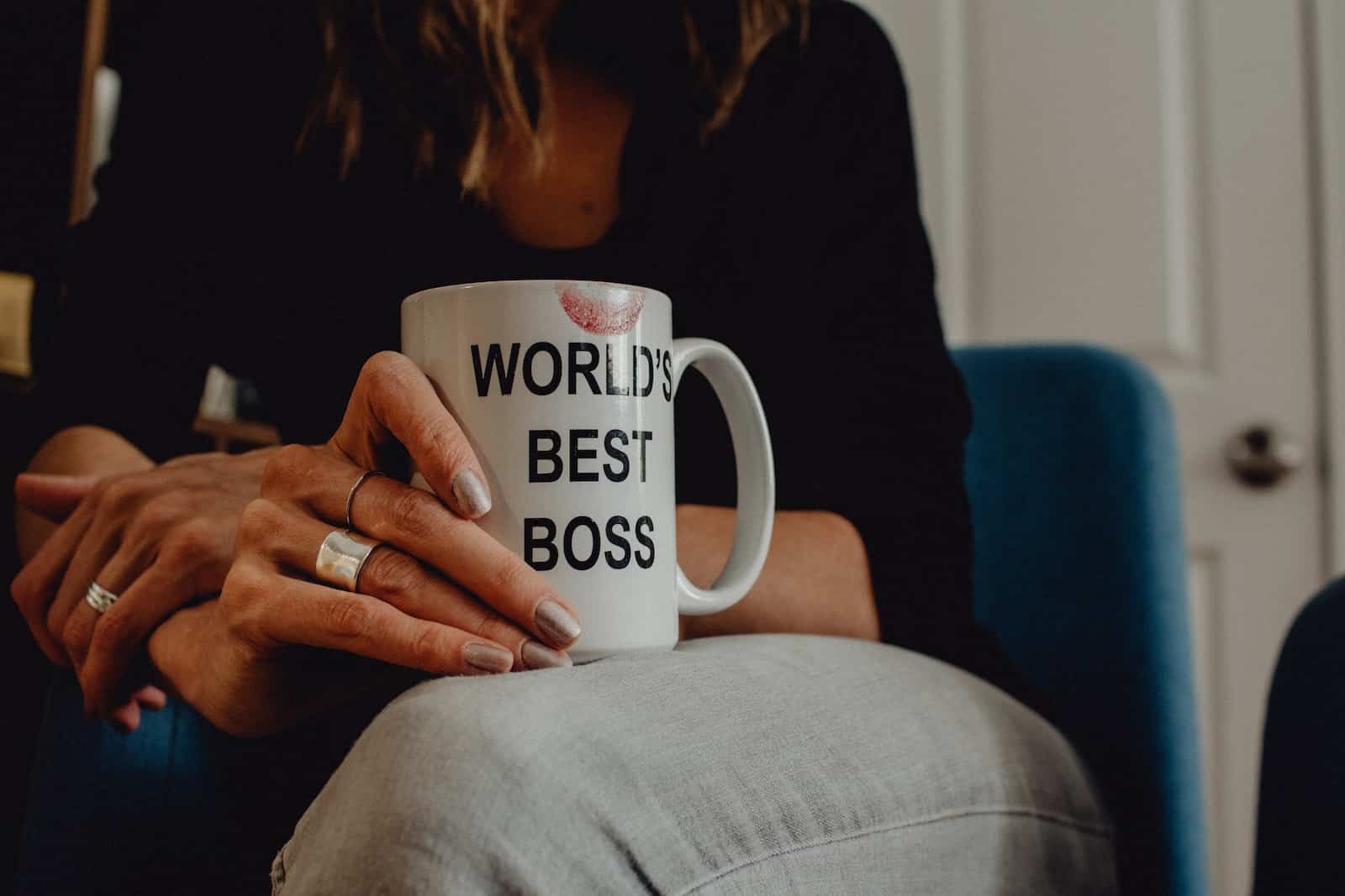 Photo by Kelly Sikkema woman in black long sleeve shirt holding white ceramic mug